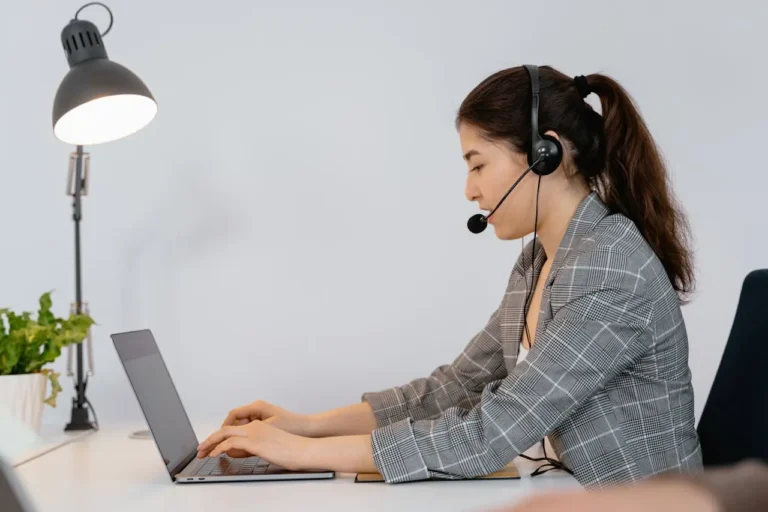 Woman providing virtual consulting services on a laptop using a headset