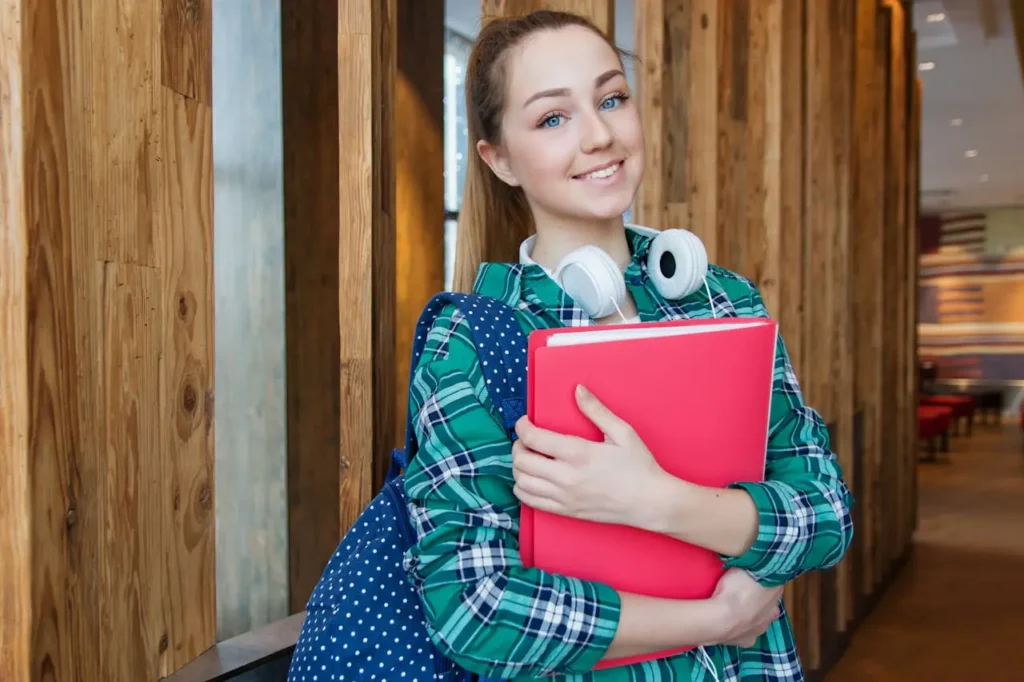 Young woman with backpack and headphones holding a folder, symbolizing certifications to earn more without a degree and career readiness without attending college.