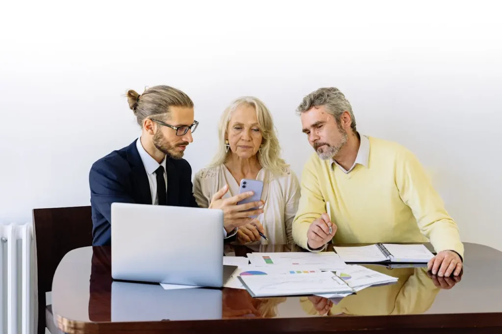 Financial advisor showing unsecured personal loan details to a middle-aged couple during a consultation.
