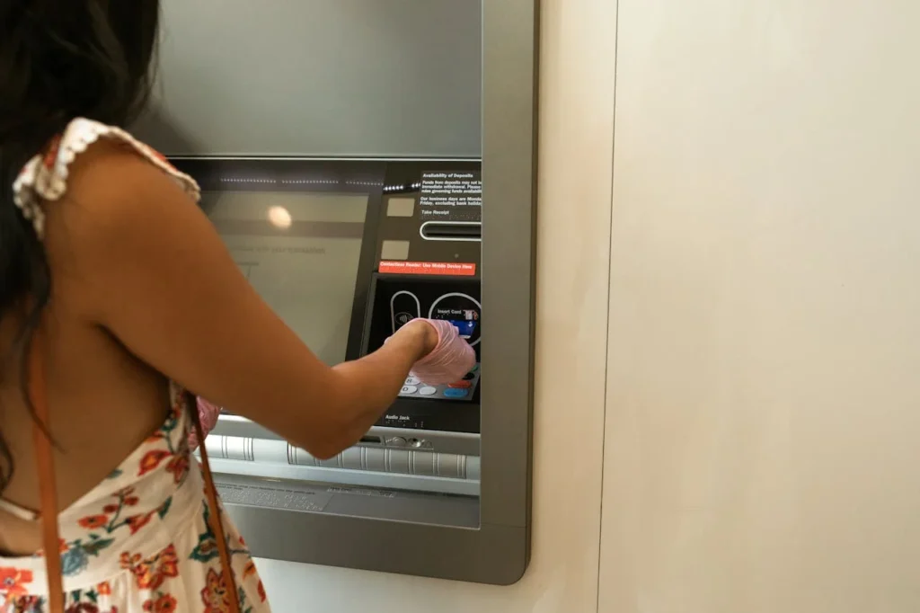 Realistic scenario of a woman at risk of ATM scams while using an unmonitored machine.