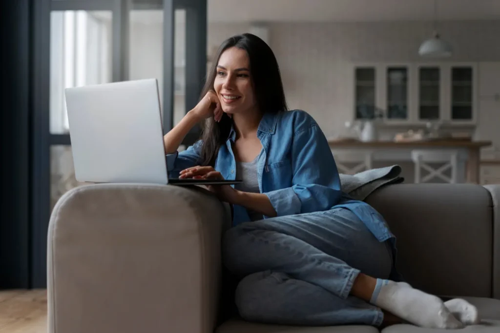 Woman working on laptop at home to make money from home in 2025.