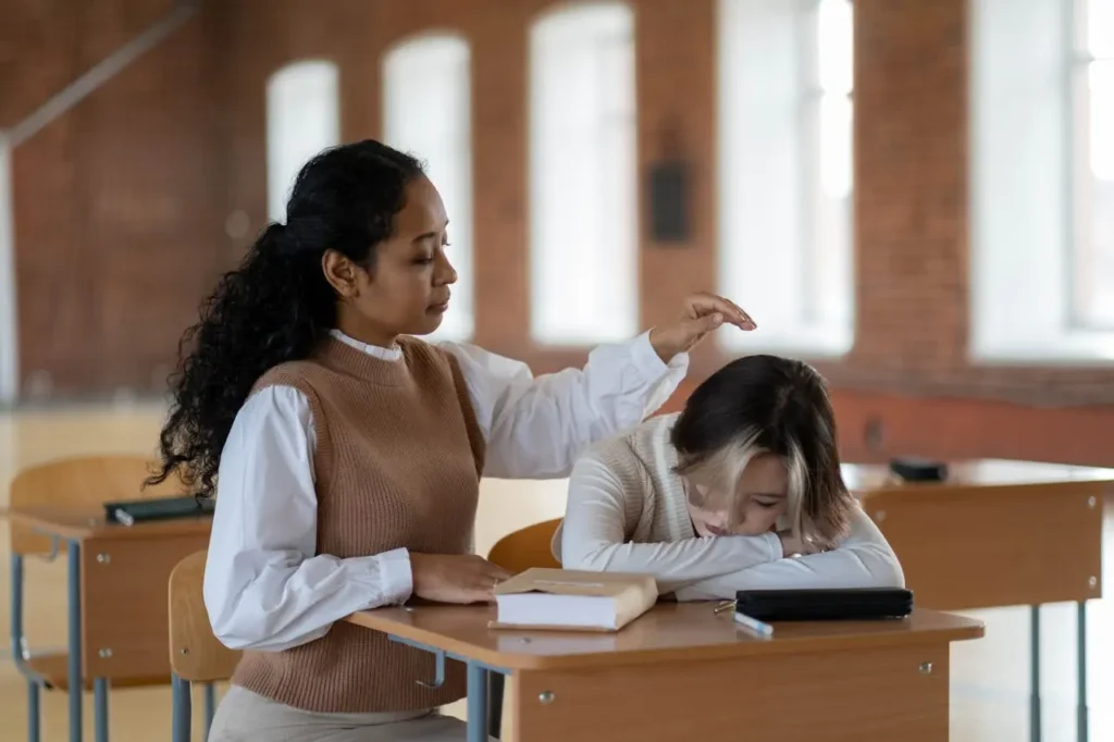 A worried student receives comfort from a classmate in a classroom, symbolizing the emotional impact of student loan mistakes and poor borrowing decisions.