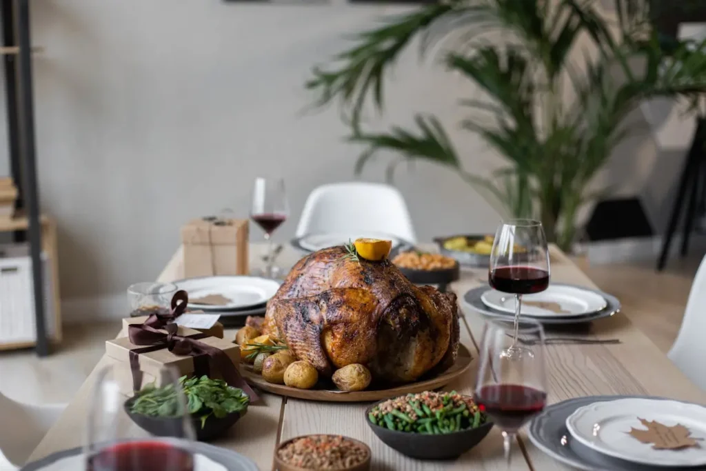 Roasted Thanksgiving turkey served with potatoes, vegetables, and wine on a holiday dinner table, symbolizing a free Thanksgiving turkey celebration.